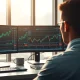 Stock charts and financial data on trading desk monitors showing momentum analysis.