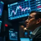 A financial trading desk monitor showing a chart of the Canadian dollar rising against the US dollar.