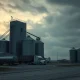 Grain elevator at dusk as corn futures prices decline ahead of key USDA report.