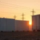 GridBeyond battery storage facility at sunset with power lines