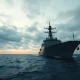 A naval vessel in the Strait of Hormuz as Iran warns of retaliation.