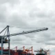 An industrial crane at a port, representing Konecranes stock after a major price target cut.