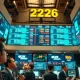 Trading floor monitors showing Mag 7 tech stock earnings data on April 25, 2026