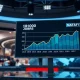 A data screen showing a positive March jobs report chart in a newsroom setting.