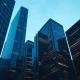 Financial district skyline representing the wave of asset manager consolidation and mergers.