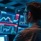 A trader monitors NZD/USD currency charts amid market volatility.