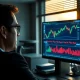 A trader monitors GBP/USD currency charts on a financial trading desk.