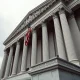 US Treasury building in Washington DC with flag, symbolizing sanctions on Iranian airlines