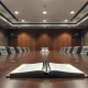 Empty diplomatic meeting table symbolizing anticipated Iran peace talks.