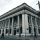 Bank of England building in London under cloudy sky, symbolizing UK bank tax debate