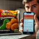 Package of dinosaur-shaped chicken nuggets with a smartphone showing a safety alert.