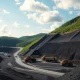 Aerial view of a large open-pit metallurgical coal mine in Appalachia with heavy machinery operating.