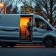 Amazon delivery van at dusk with driver handing package to customer