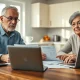 Older couple reviewing Social Security documents at a kitchen table, planning retirement timing.