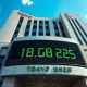 Tokyo Stock Exchange building with Nikkei 225 index showing record high on digital display.