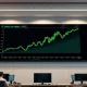 Bitcoin price chart showing upward breakout on a trading floor screen during CLARITY Act markup