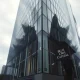 Blue Owl Capital office building with subdued lighting and a lone figure walking away, reflecting fundraising decline.