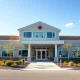 Modern senior living facility exterior on a sunny day, representing CareTrust REIT's healthcare real estate portfolio.