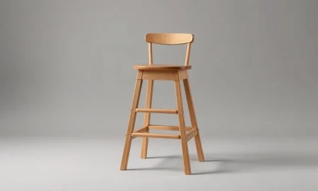 A wooden children's tower stool isolated on a neutral background, subject of a nationwide recall.