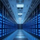 Interior of a modern data centre with rows of servers and blue lighting, representing DayOne's core business.