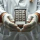 Food safety inspector holding a chocolate bar package during a Salmonella contamination recall inspection