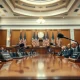 US congressional committee hearing room with microphones and American flags, representing the CLARITY Act markup session.