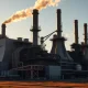 Aerial view of a large steel manufacturing plant at sunrise, representing Cleveland-Cliffs industrial operations.