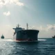 Oil tanker in the Strait of Hormuz with naval escort under cloudy sky