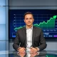 News anchor reporting on Bitcoin recovery with green price chart in background