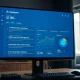 Digital news aggregation dashboard on a monitor in a modern newsroom setting