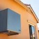 A modern residential heat pump unit installed on the exterior wall of a house, representing Sadi Thermal Machines' technology.