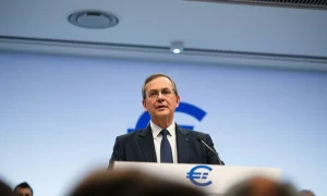 ECB Chief Economist Philip Lane speaking at a press conference, warning about oil shock and rate hikes.