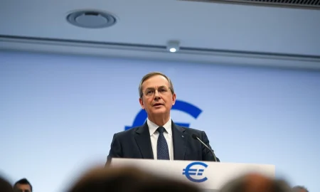 ECB Chief Economist Philip Lane speaking at a press conference, warning about oil shock and rate hikes.