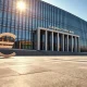 European Central Bank headquarters in Frankfurt with a rising euro symbol reflection on the plaza, representing currency strength amid geopolitical developments.
