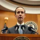 Chicago Federal Reserve President Austan Goolsbee speaking at a press conference about the labor market and monetary policy.