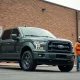 Ford F-150 truck with workers and small business owner outside a Carhartt-branded industrial building