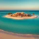 Aerial view of a modern luxury island home with beach and ocean during golden hour