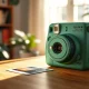 Fujifilm Instax Wide 400 camera in green with a printed instant photo on a wooden table