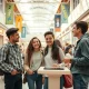Gen Z shoppers socializing at a bright, modern mall with interactive retail displays