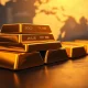 Stacked gold bars on a table with a financial chart background