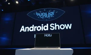 Google Android Show stage with Googlebook laptop and Gemini AI interface
