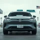 Chinese electric vehicle at US-Canada border crossing under overcast sky