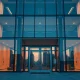 Modern office building at dusk with digital network overlays representing institutional crypto investment