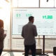 Modern office with digital display showing Gusto's $1 billion revenue milestone