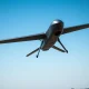 Helsing military drone in flight over a European test range under a clear sky