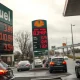 Gas station price sign showing high fuel costs amid rising inflation due to Iran conflict.