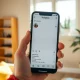 Instagram Instants feature displayed on a smartphone in a sunlit room