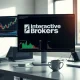 Interactive Brokers trading desk with multiple monitors showing financial charts.