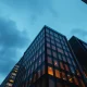 Exterior of a modern office building in Manhattan's Financial District at dusk, representing Jane Street's headquarters.