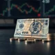 Japanese Yen banknotes and coins on a desk with subtle trading desk background